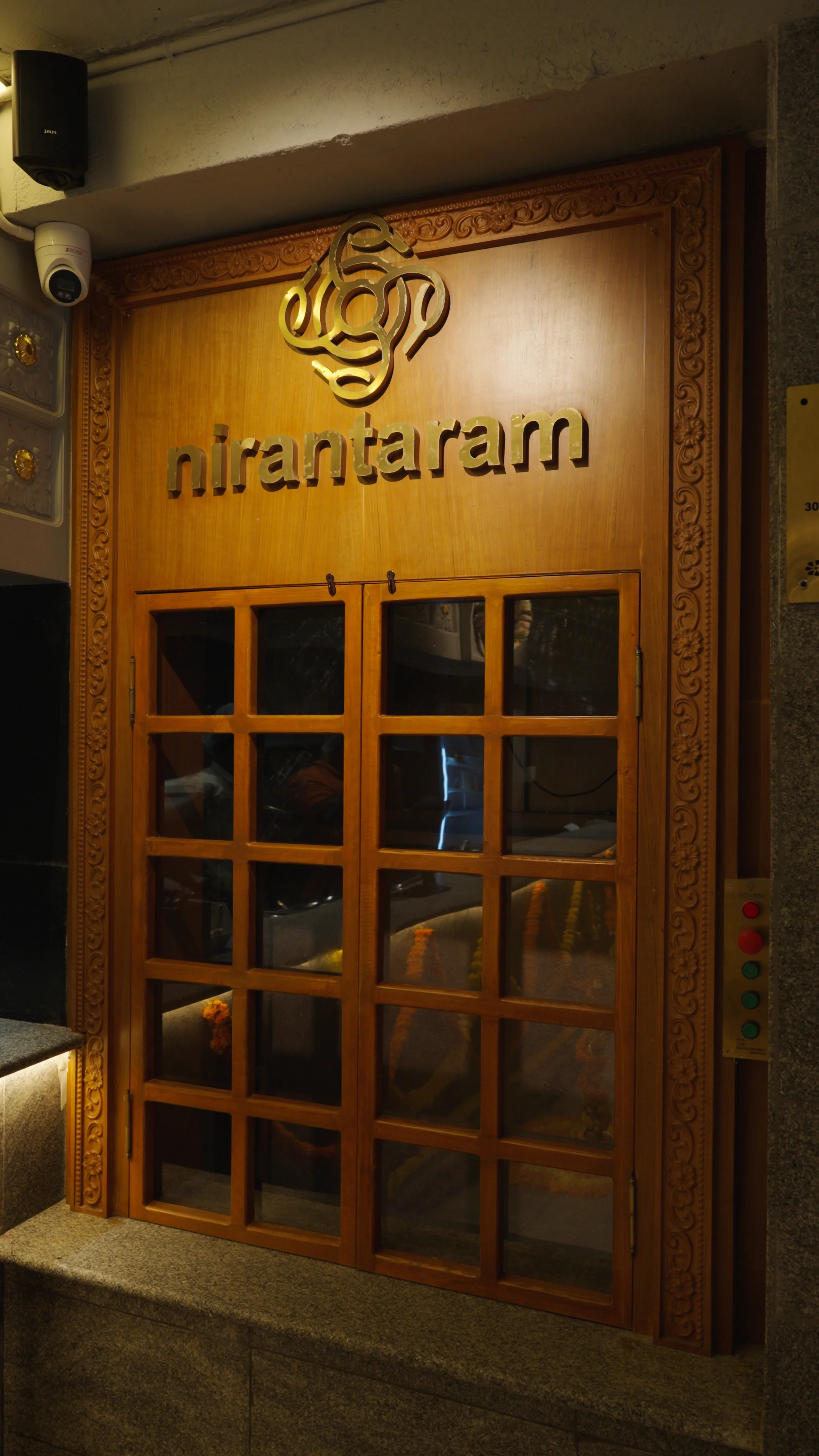 Nirantharam Teak Service Hatch and Brass Logo